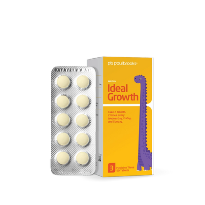 Packaging of 'Ideal Growth' tablets with a dinosaur illustration on a white background